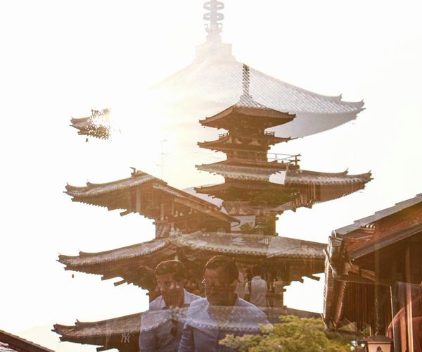Silhouette of a person meditating against an ancient temple backdrop.